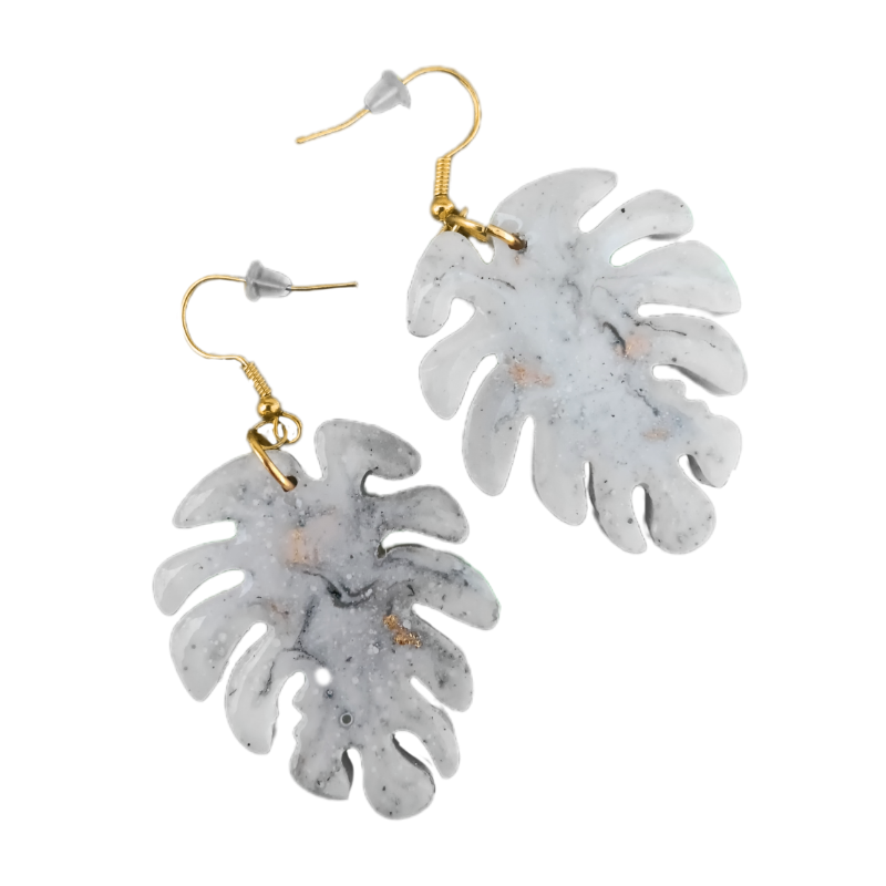 These trending faux marble dangles are the most wanted accessory of the season, featuring a sought-after white and grey swirled finish with gold-flecked accents that have gone viral across social media. Each pair of these high-demand handmade earrings is suspended from golden alloy hooks, making them the must-have jewelry item for beach lovers and plant enthusiasts alike. This viral jewelry design captures the essence of the most popular tropical trends, catering to the massive demand for aesthetic resin accessories and highly coveted botanical statement pieces. As a viral sensation in the handmade market, these monstera leaf drops represent the most wanted style for summer, proving why these specific marbleized earrings are in such high demand globally.
